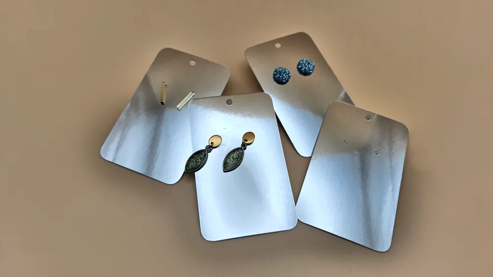 Laser-cut earring display cards with mounted earrings